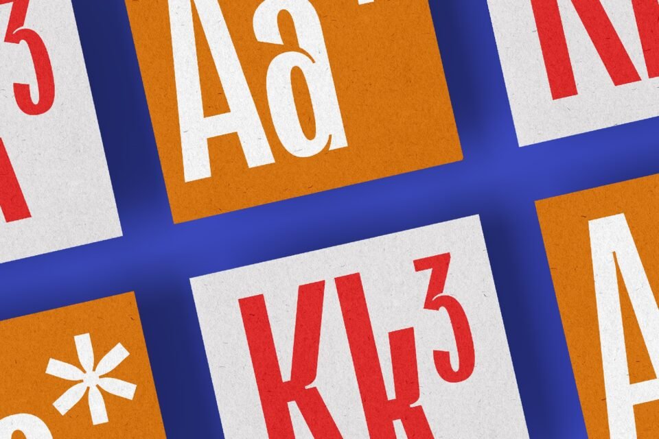 A close-up view of a few characters from the Orstavic font, including the letters "Aa" and "Kk" and a number "3." The letters are displayed on orange and white squares with a blue background.